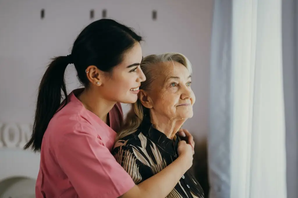 Senior patient with home care nurse Happy senior woman talking with Support Worker
