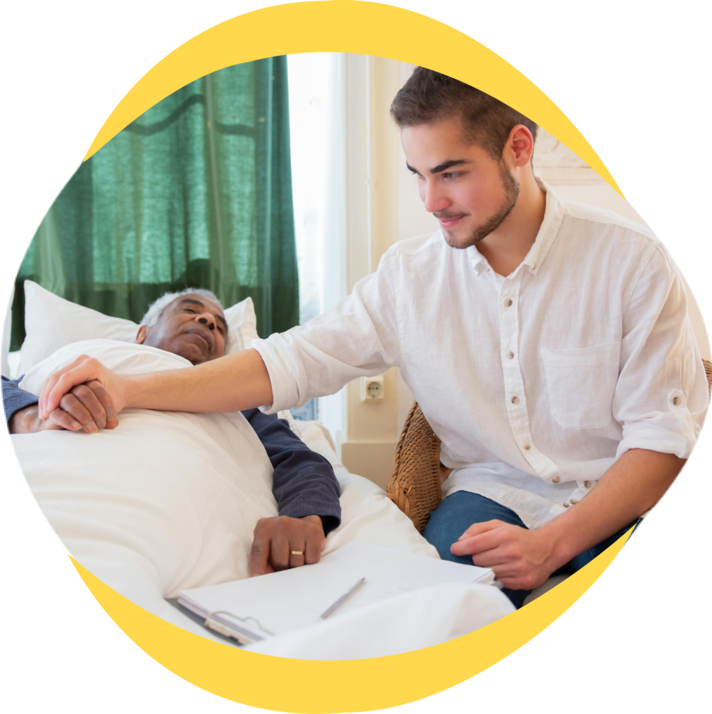 support worker with elderly person in bed