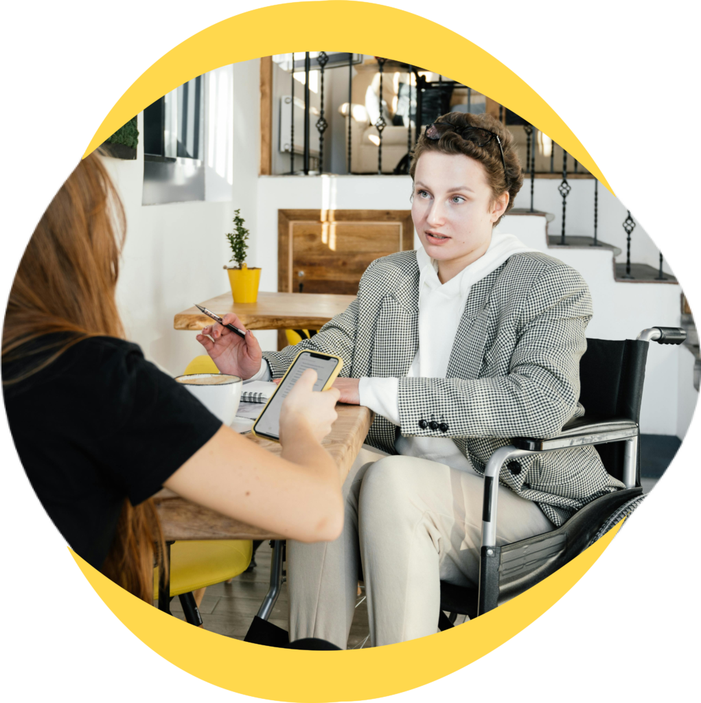 Person in wheelchair talking to support worker